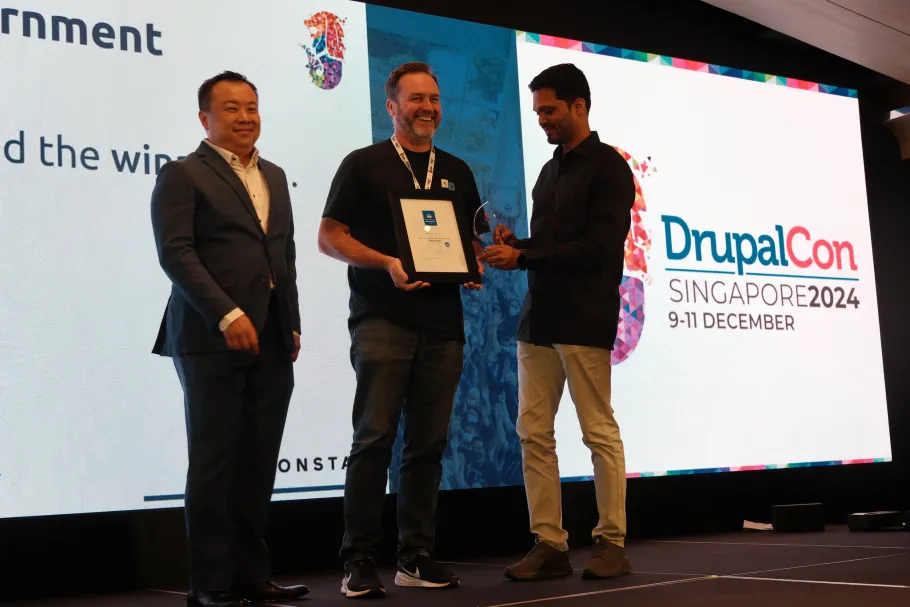 Kim Pepper recieving the award for best site in the Government category at DrupalCon Singapore